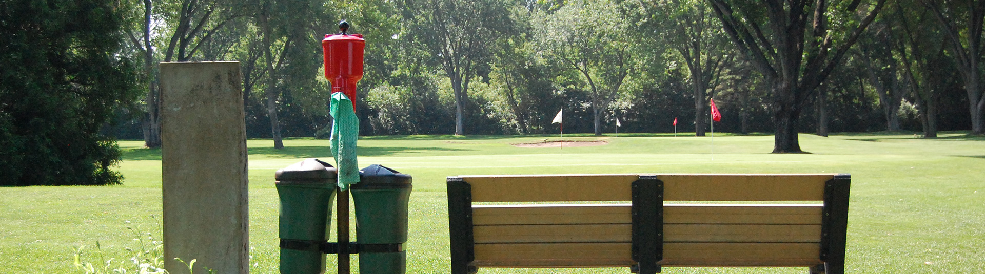 View of the course with the back of a bench in the foreground 